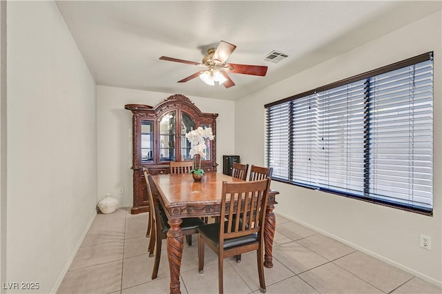 dining room featuring light tile patterned floors, baseboards, visible vents, and a ceiling fan