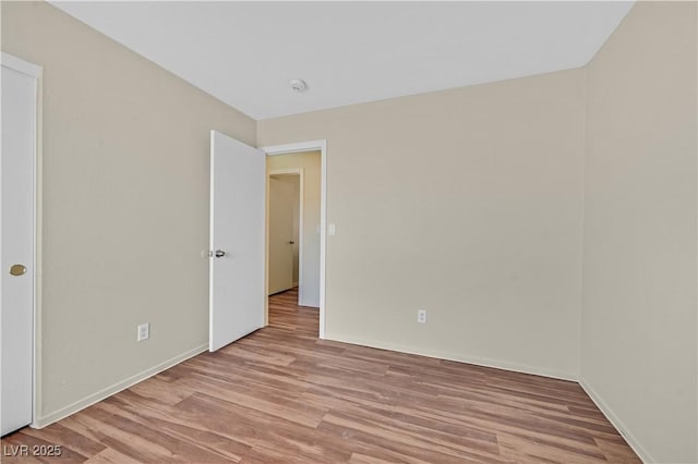 unfurnished room featuring light wood-style floors and baseboards