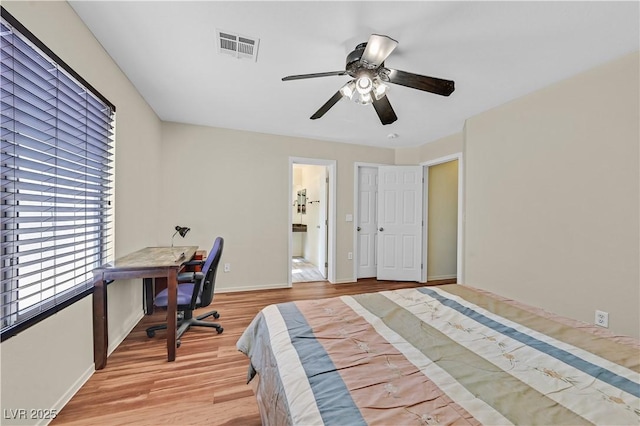 bedroom with baseboards, visible vents, ceiling fan, and light wood finished floors