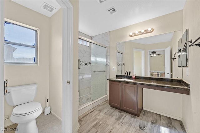 full bath featuring visible vents, a shower stall, toilet, and vanity