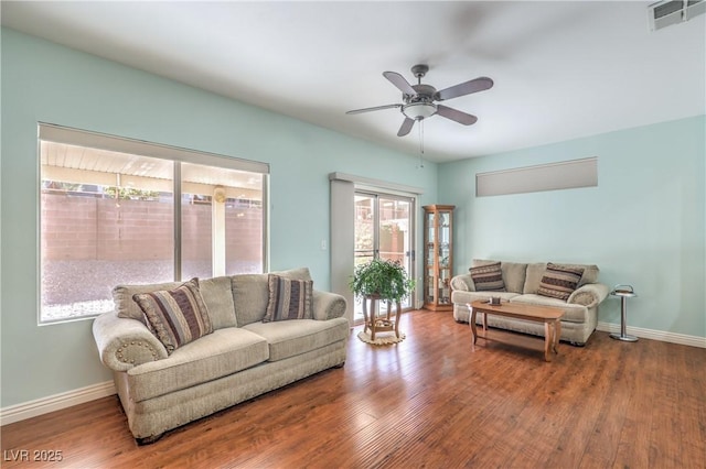 living room with hardwood / wood-style flooring and ceiling fan