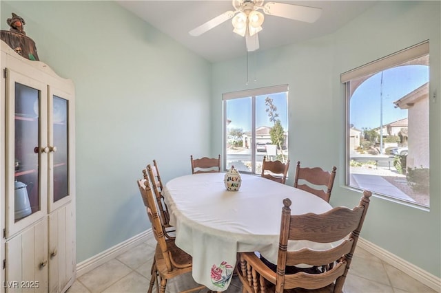 tiled dining space with ceiling fan