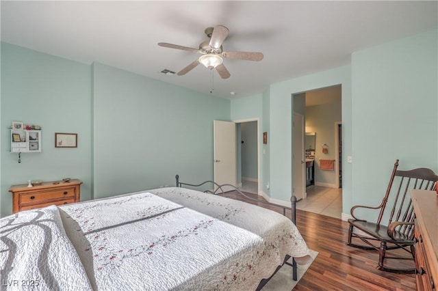 bedroom with ceiling fan, hardwood / wood-style floors, and ensuite bath