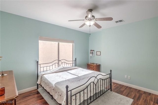 bedroom with dark hardwood / wood-style floors and ceiling fan