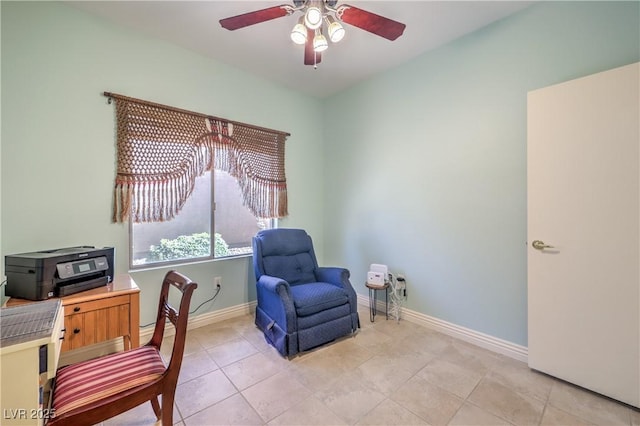 living area featuring light tile patterned floors and ceiling fan