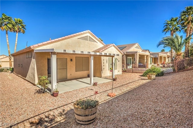 rear view of property featuring a patio