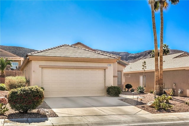 ranch-style house featuring a garage and a mountain view