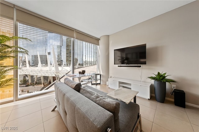 tiled living room featuring a wall of windows