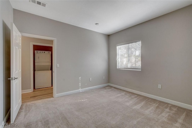 5250 S Rainbow Blvd Unit 2165, Las Vegas, NV 89118 - unfurnished room with stacked washer / dryer and carpet flooring