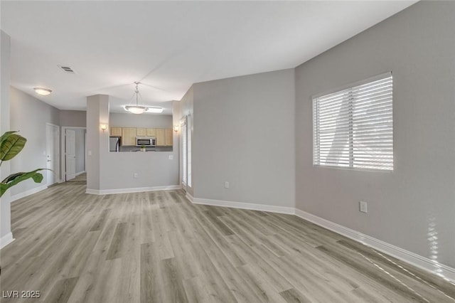 5250 S Rainbow Blvd Unit 2165, Las Vegas, NV 89118 - unfurnished living room with baseboards and light wood-style flooring