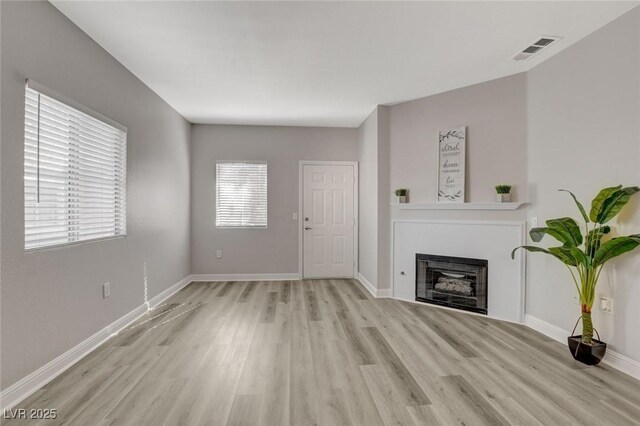 5250 S Rainbow Blvd Unit 2165, Las Vegas, NV 89118 - unfurnished living room with light wood finished floors and a fireplace