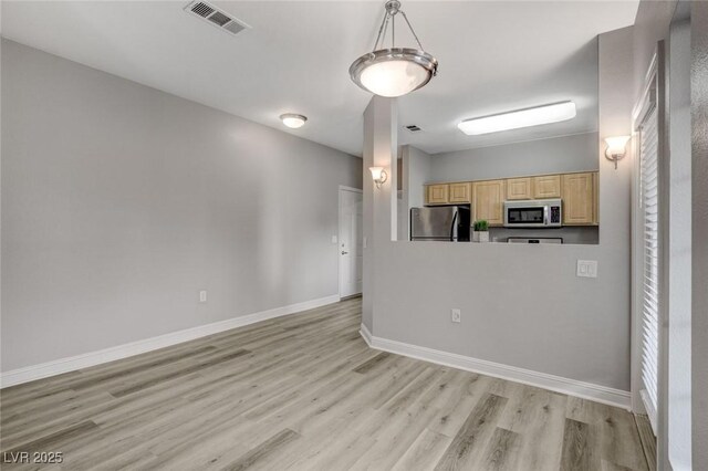 5250 S Rainbow Blvd Unit 2165, Las Vegas, NV 89118 - kitchen with stainless steel appliances, light brown cabinets, and light wood finished floors