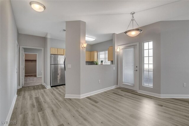 5250 S Rainbow Blvd Unit 2165, Las Vegas, NV 89118 - kitchen featuring freestanding refrigerator, light brown cabinetry, light wood-style floors, and decorative light fixtures