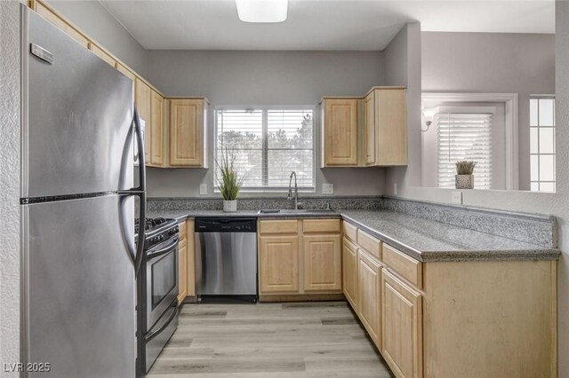 5250 S Rainbow Blvd Unit 2165, Las Vegas, NV 89118 - kitchen featuring stainless steel appliances, light brown cabinetry, a peninsula, and light wood finished floors