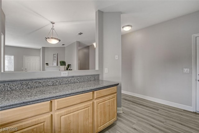5250 S Rainbow Blvd Unit 2165, Las Vegas, NV 89118 - kitchen with light wood-style floors, decorative light fixtures, and light brown cabinets
