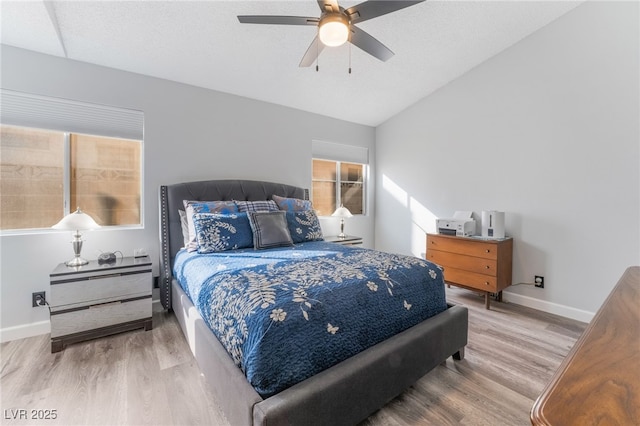 bedroom featuring hardwood / wood-style flooring, vaulted ceiling, a textured ceiling, and ceiling fan