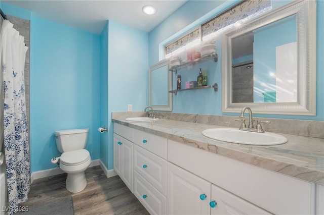 bathroom featuring vanity, hardwood / wood-style flooring, toilet, and a shower with shower curtain