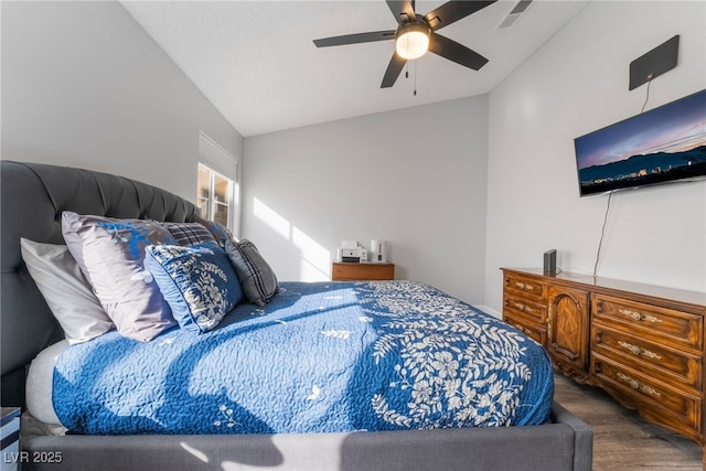 bedroom featuring hardwood / wood-style flooring, vaulted ceiling, and ceiling fan