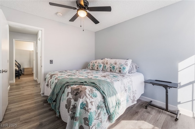 bedroom featuring ceiling fan, hardwood / wood-style floors, and a textured ceiling