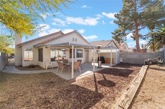 rear view of property featuring a patio