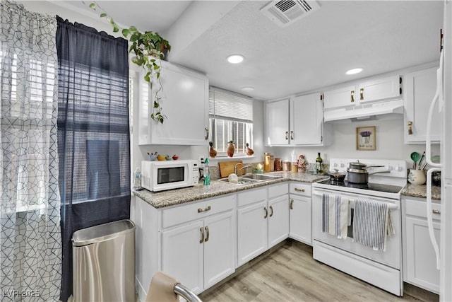 kitchen featuring sink, white appliances, light hardwood / wood-style flooring, light stone counters, and white cabinets