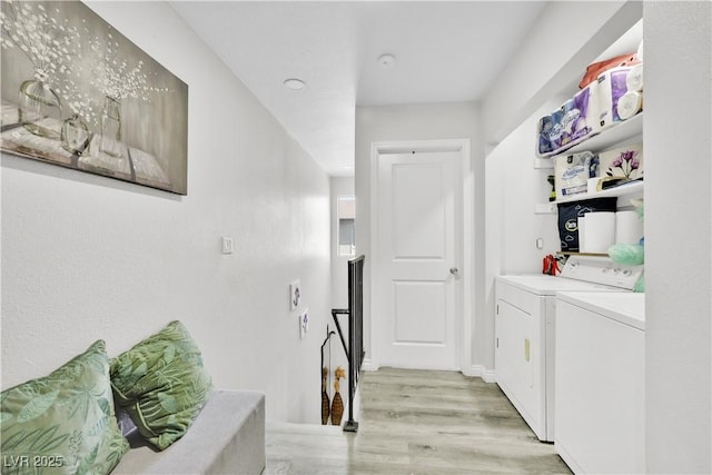 laundry area featuring washer and dryer and light wood-type flooring