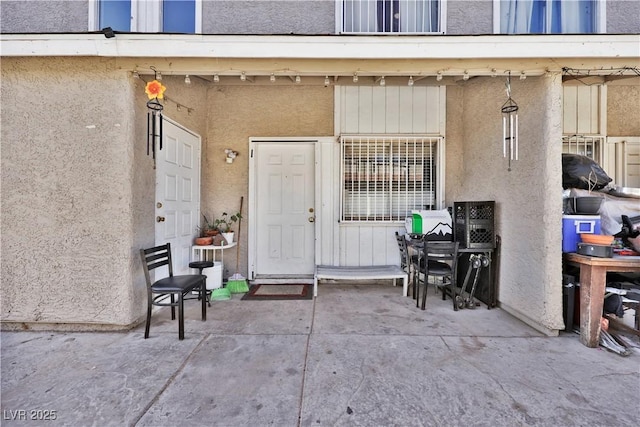 view of exterior entry featuring a patio area