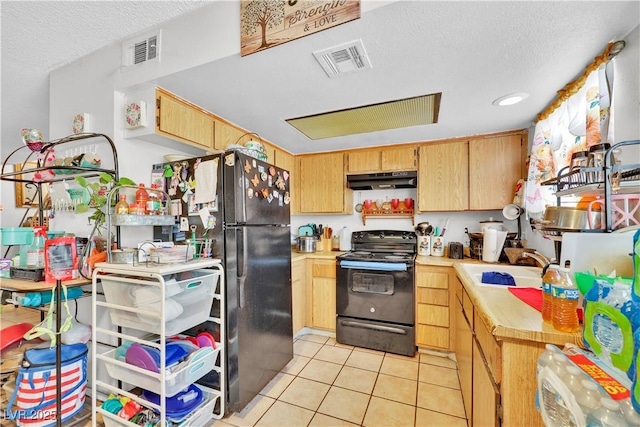 kitchen with light tile patterned flooring, sink, a textured ceiling, and black appliances