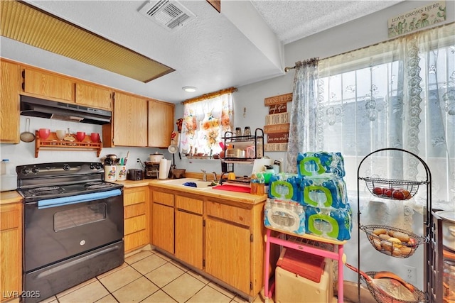 kitchen with black range with electric cooktop, plenty of natural light, sink, and light tile patterned flooring