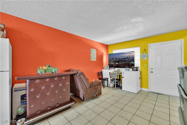 tiled living room featuring washer / clothes dryer and a textured ceiling