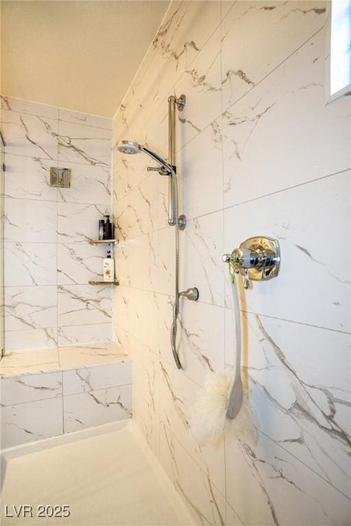 full bathroom with a marble finish shower