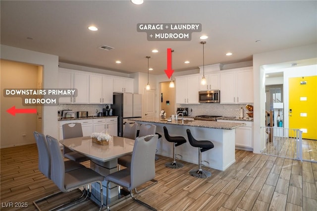 kitchen featuring backsplash and refrigerator