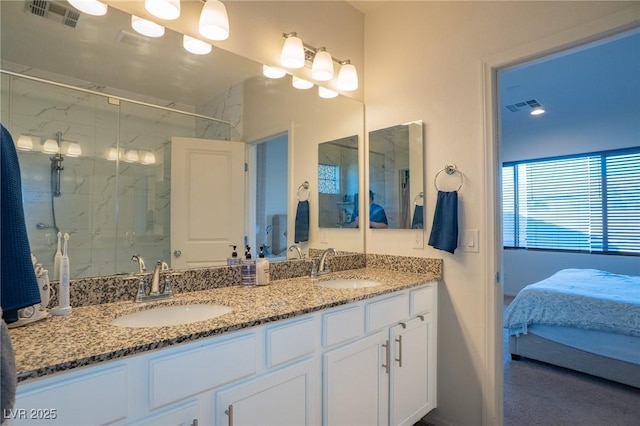 bathroom with a shower with door and vanity