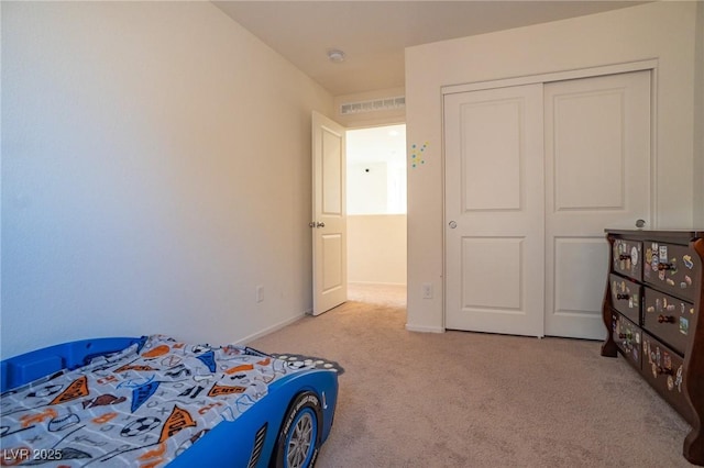 bedroom featuring carpet floors, a closet, visible vents, and baseboards