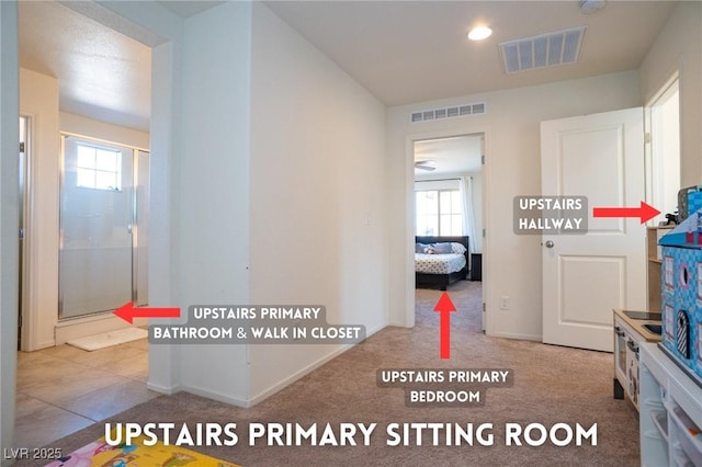 hallway featuring visible vents and baseboards