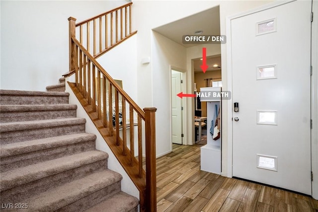 staircase with wood finished floors