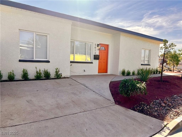 view of front of house featuring a patio area and stucco siding