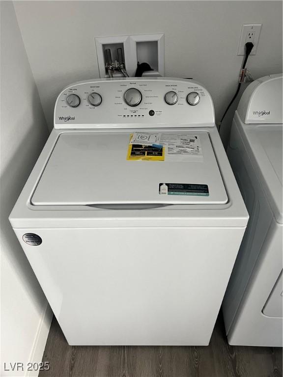 washroom with dark wood-style floors, laundry area, and washer / clothes dryer