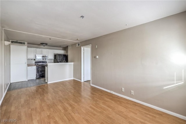 unfurnished living room featuring light wood-type flooring