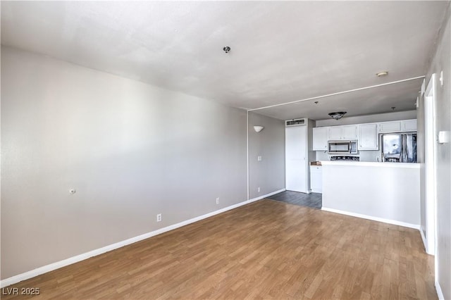 unfurnished living room featuring wood-type flooring