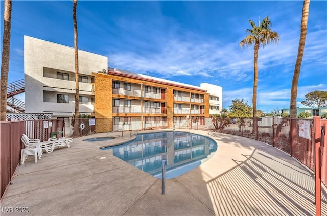 view of pool featuring a patio and a community hot tub