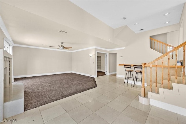 unfurnished living room with light carpet, ornamental molding, and ceiling fan