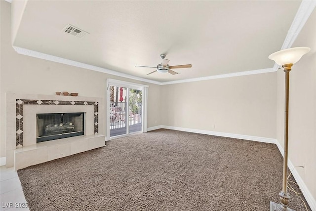 unfurnished living room with crown molding, ceiling fan, a fireplace, and carpet flooring