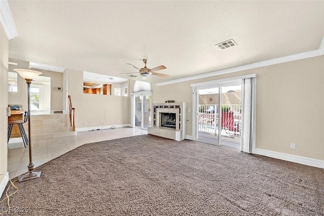 unfurnished living room with ceiling fan, light colored carpet, and ornamental molding