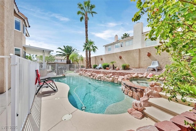view of pool with an in ground hot tub