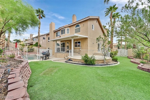 rear view of property with a patio area and a lawn
