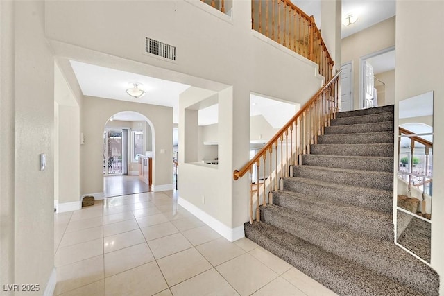 tiled entryway with a high ceiling