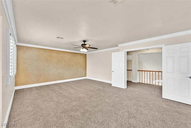 empty room featuring crown molding, ceiling fan, and carpet