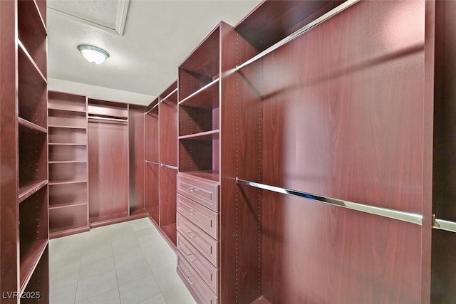 spacious closet with light tile patterned floors