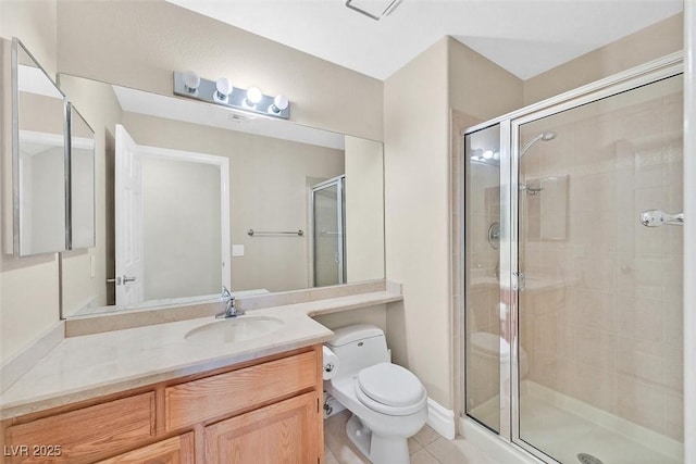 bathroom featuring tile patterned flooring, vanity, a shower with shower door, and toilet